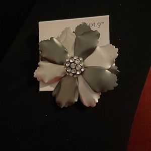 Grey silver floral pin.